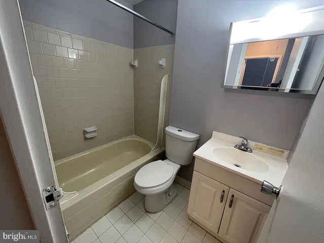 a white toilet sitting next to a bath tub