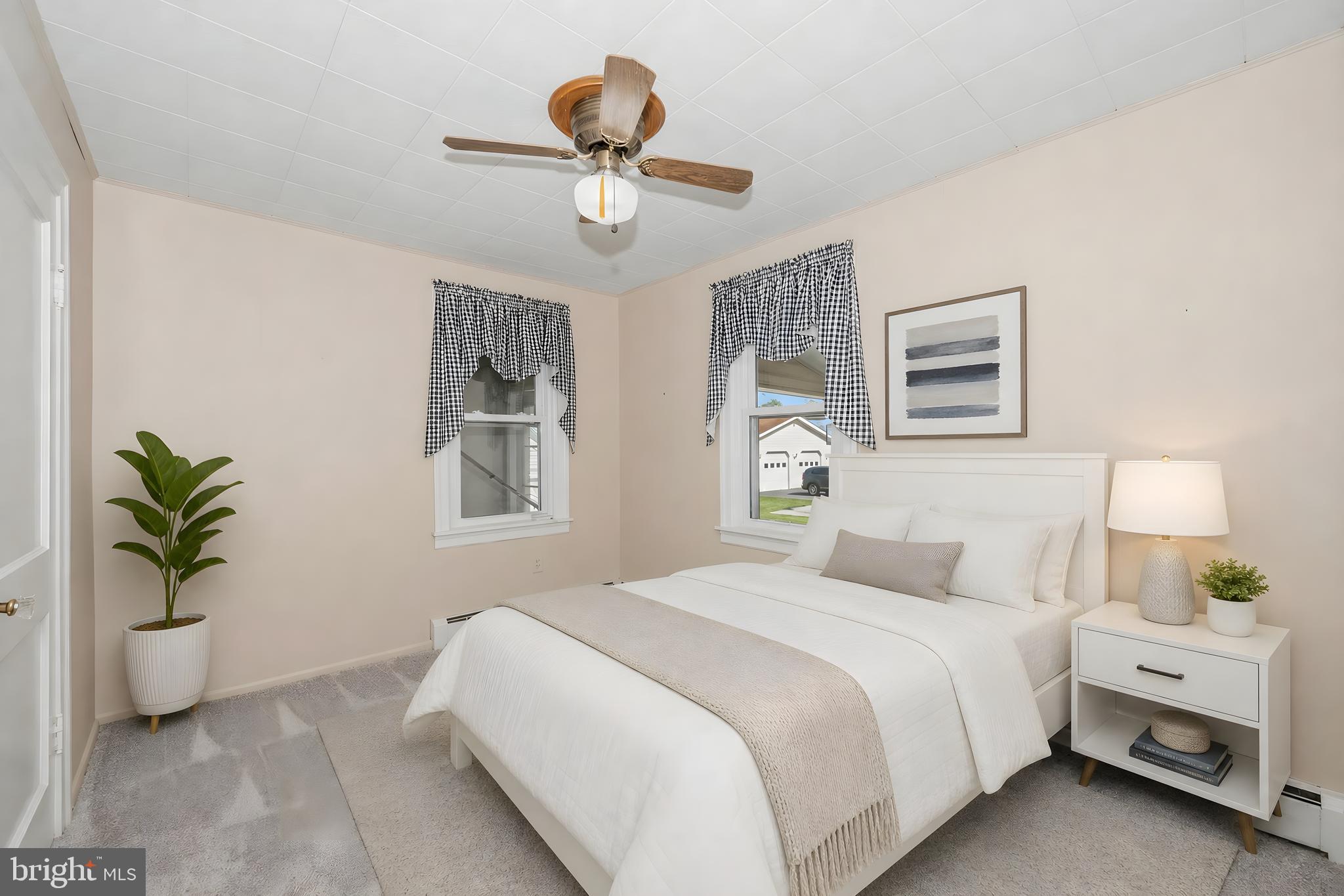 11205 Hessong Bridge Road Thurmont, MD 21788 - Photo 22 of 69 a bedroom with a bed and a potted plant