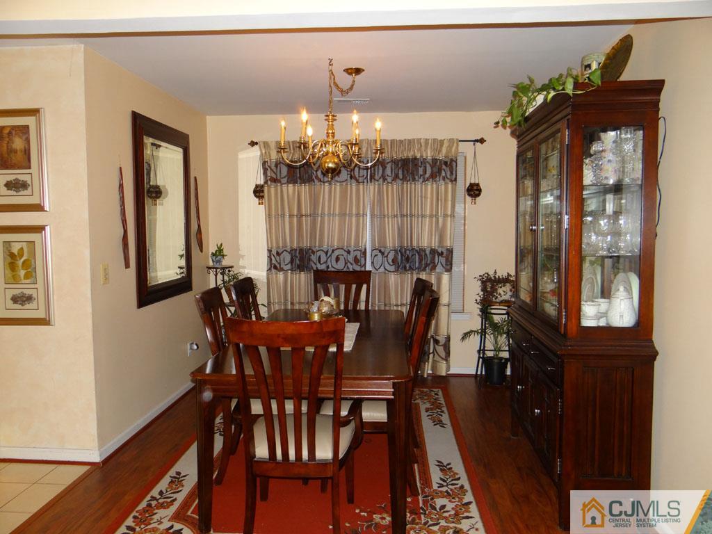 92 Woodbury Road Edison, NJ 08820 - Photo 5 of 16 a view of a dining room with furniture and chandelier