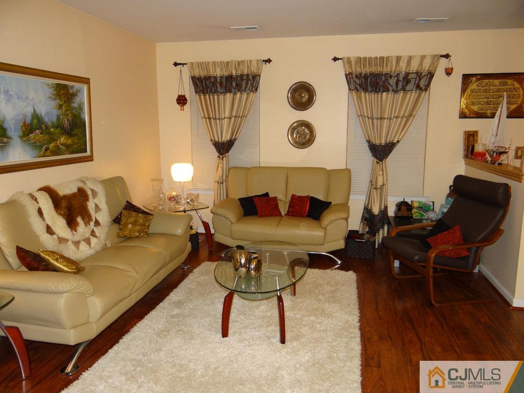 92 Woodbury Road Edison, NJ 08820 - Photo 6 of 16 a living room with furniture and a table