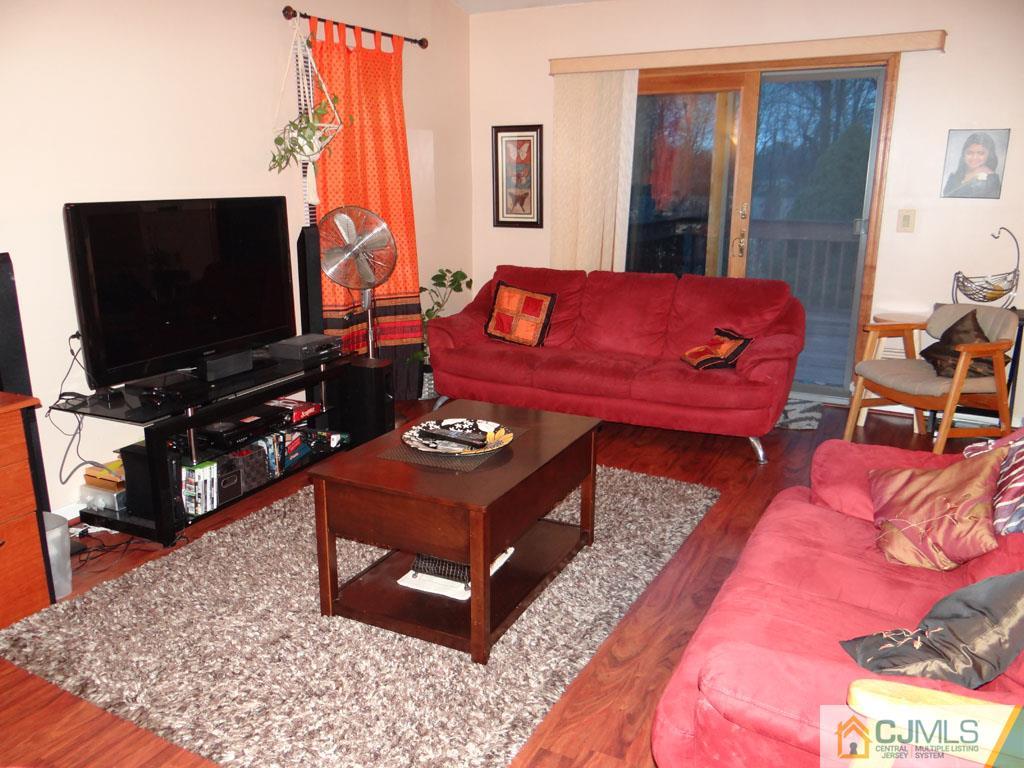 92 Woodbury Road Edison, NJ 08820 - Photo 7 of 16 a living room with furniture and a flat screen tv