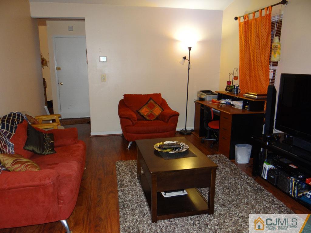 92 Woodbury Road Edison, NJ 08820 - Photo 8 of 16 a living room with furniture and a flat screen tv