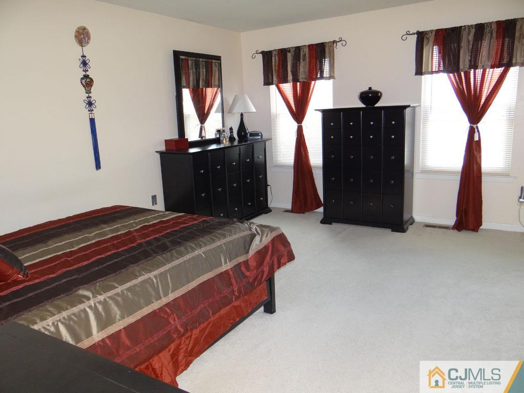 92 Woodbury Road Edison, NJ 08820 - Photo 10 of 16 a bedroom with a bed and a dresser