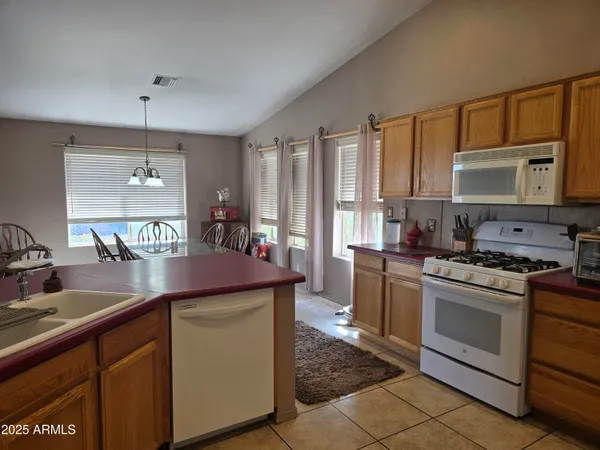 a large kitchen with a table and chairs