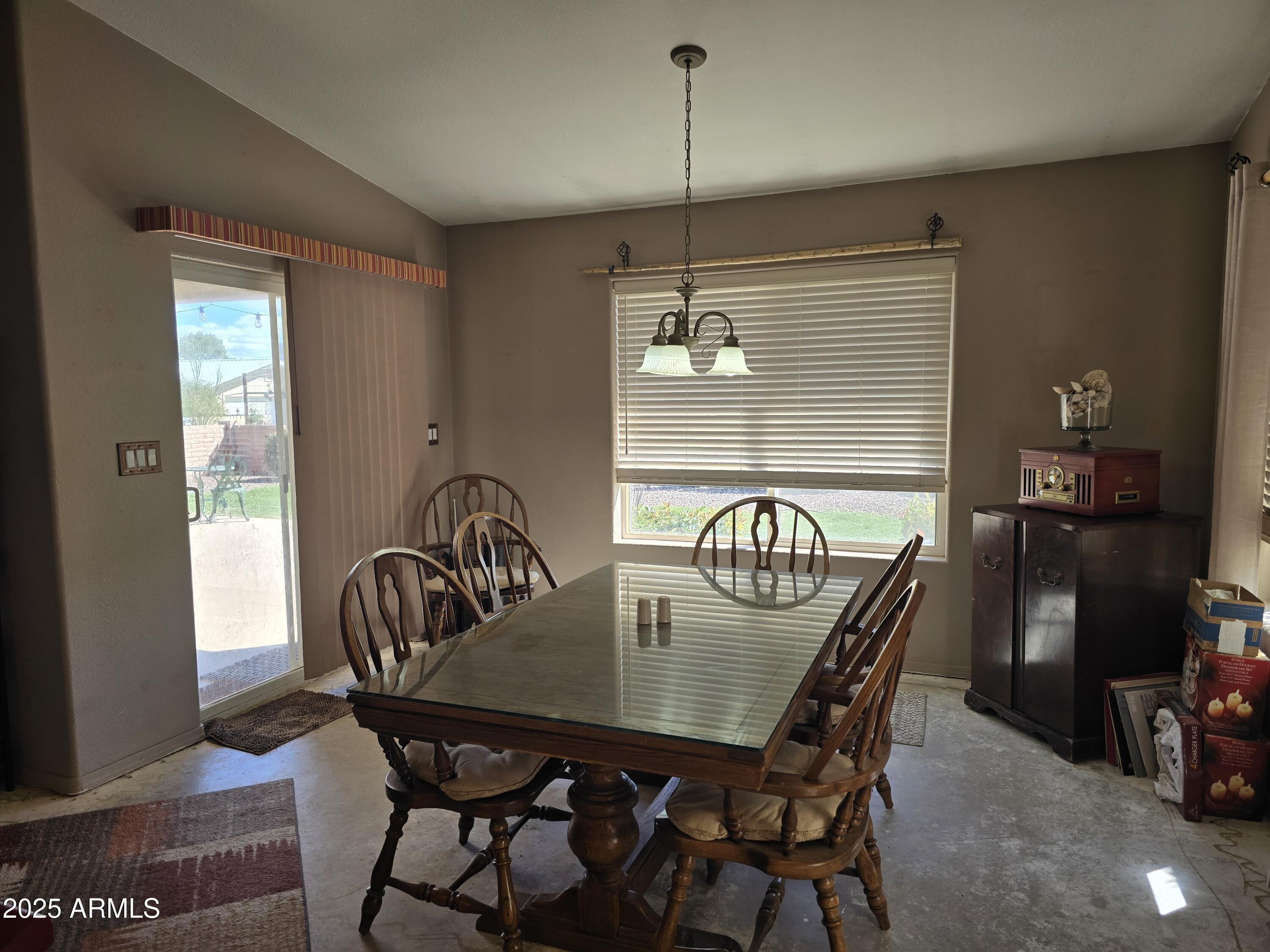 924 West Sahuaro Road Pearce, AZ 85625 - Photo 14 of 32 a view of a dining room with furniture window and wooden floor