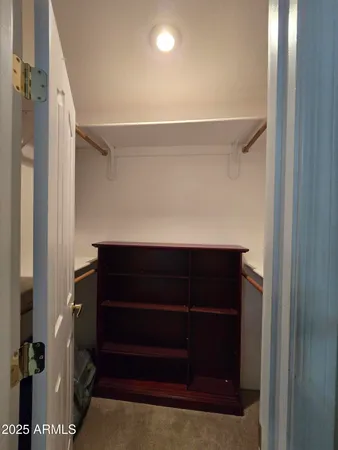 a bedroom with two beds and a chair