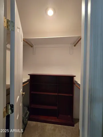 a bedroom with two beds and a chair