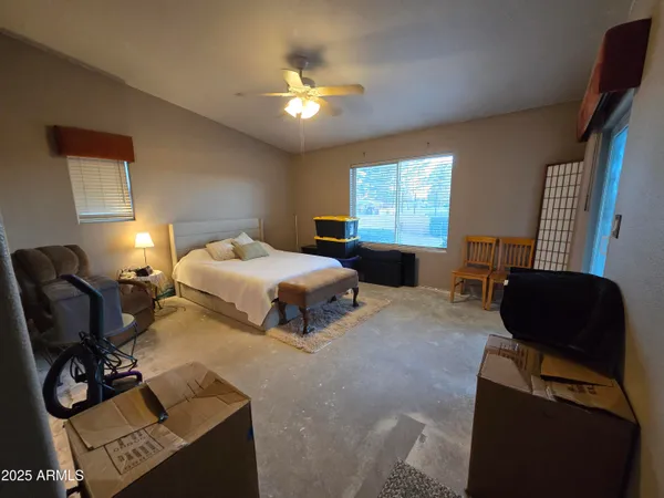 a bedroom with a bed and window