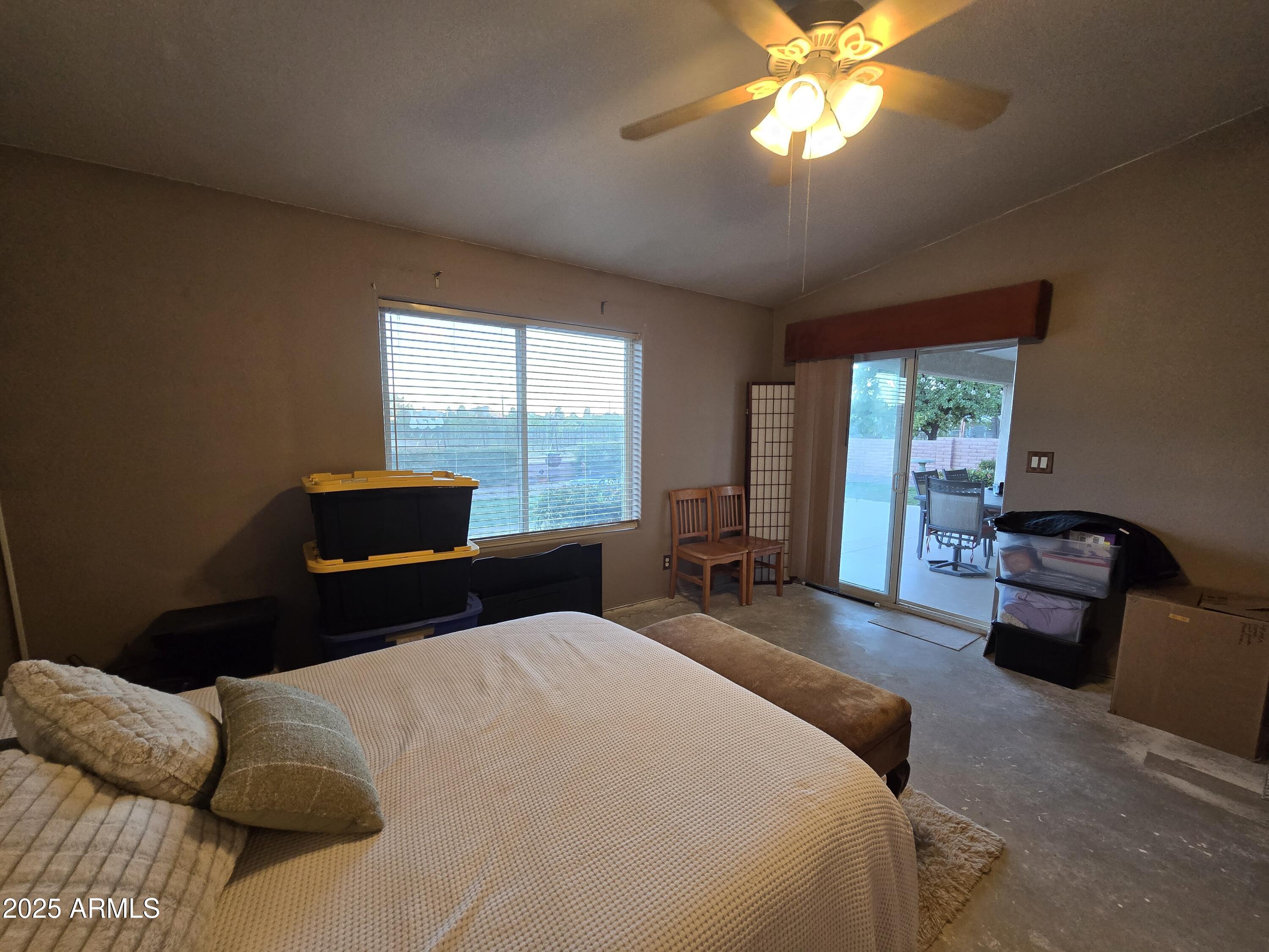 924 West Sahuaro Road Pearce, AZ 85625 - Photo 23 of 32 a bedroom with a bed and a chandelier