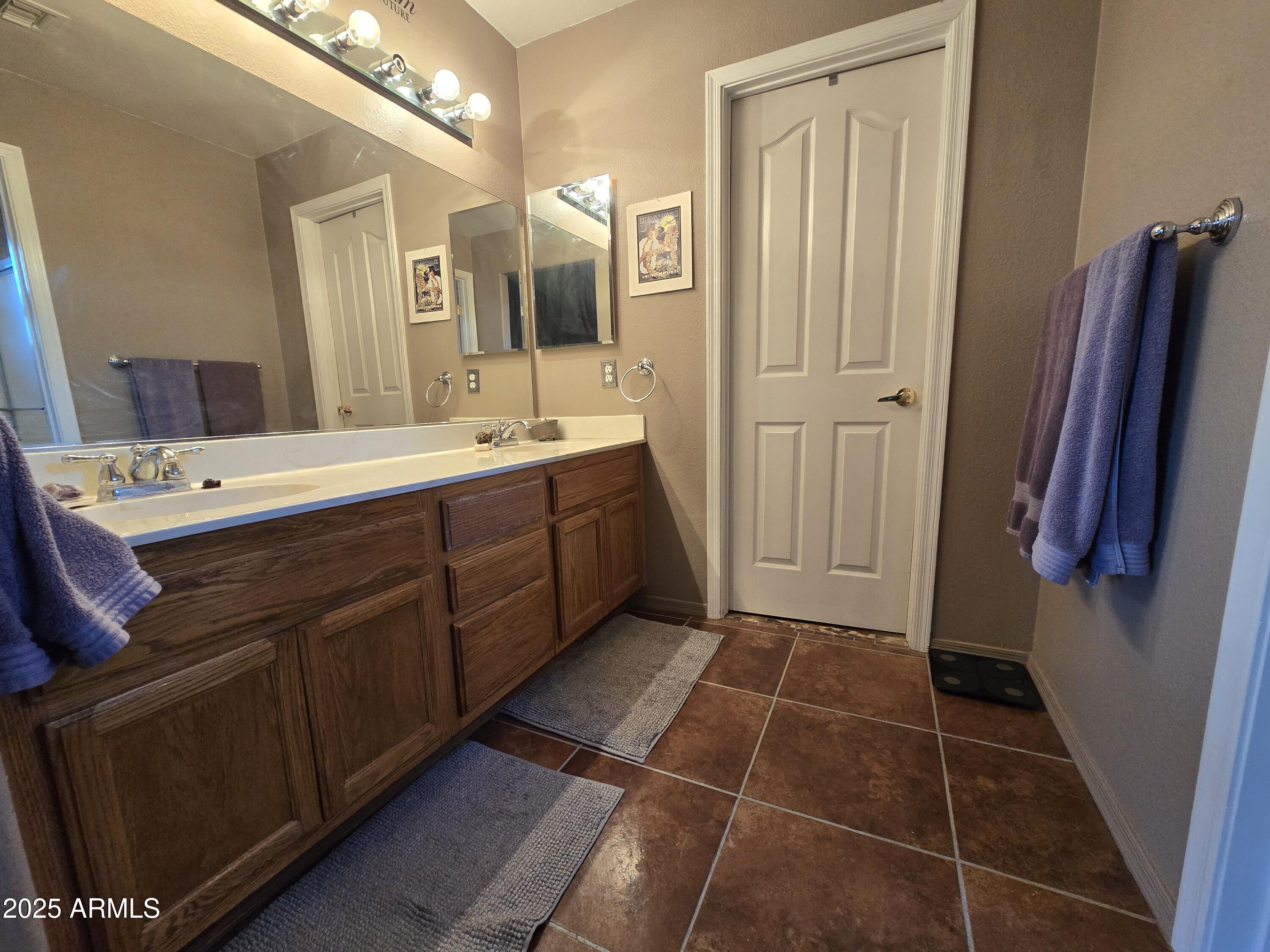 924 West Sahuaro Road Pearce, AZ 85625 - Photo 24 of 32 a room with a mirror and a sink