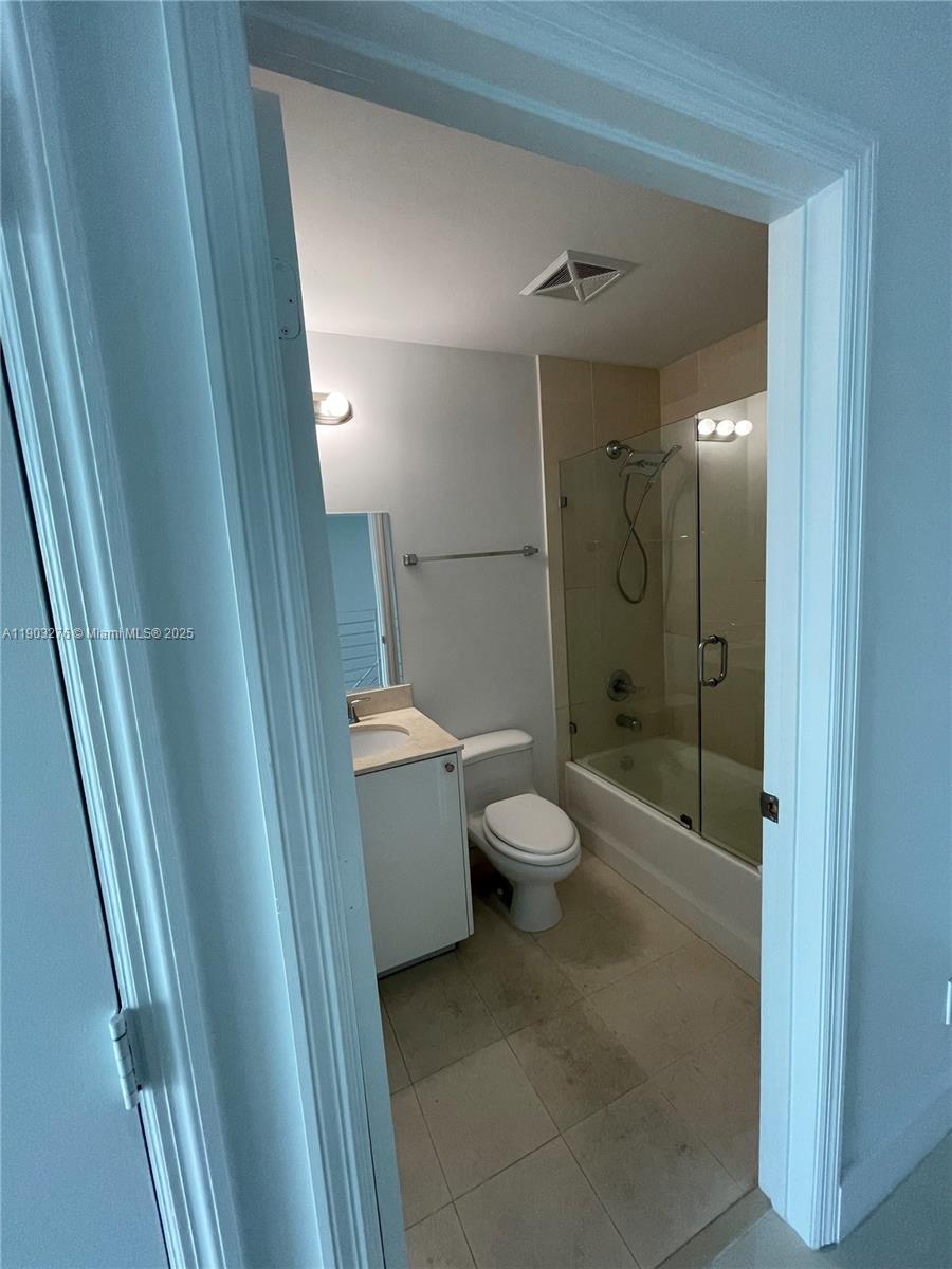 60 Southwest 13th Street, Unit 2213 Miami, FL 33130 - Photo 13 of 19 a bathroom with a granite countertop toilet sink and shower