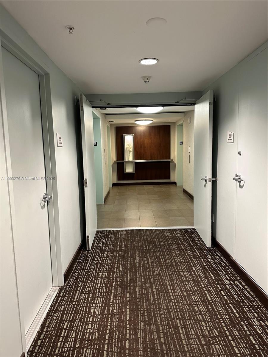 60 Southwest 13th Street, Unit 2213 Miami, FL 33130 - Photo 15 of 19 an empty room with wooden floor and a fireplace