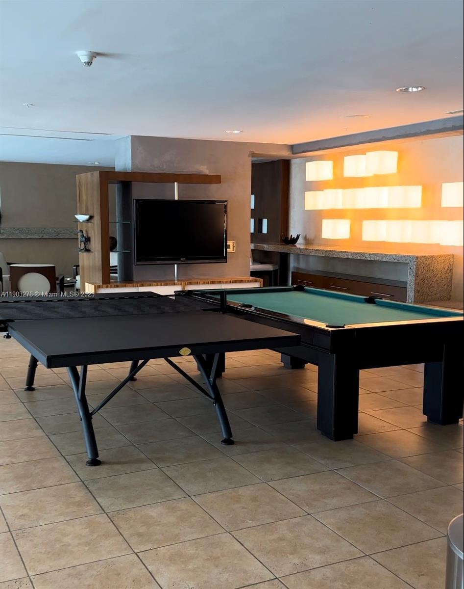 60 Southwest 13th Street, Unit 2213 Miami, FL 33130 - Photo 18 of 19 a room with pool table and windows