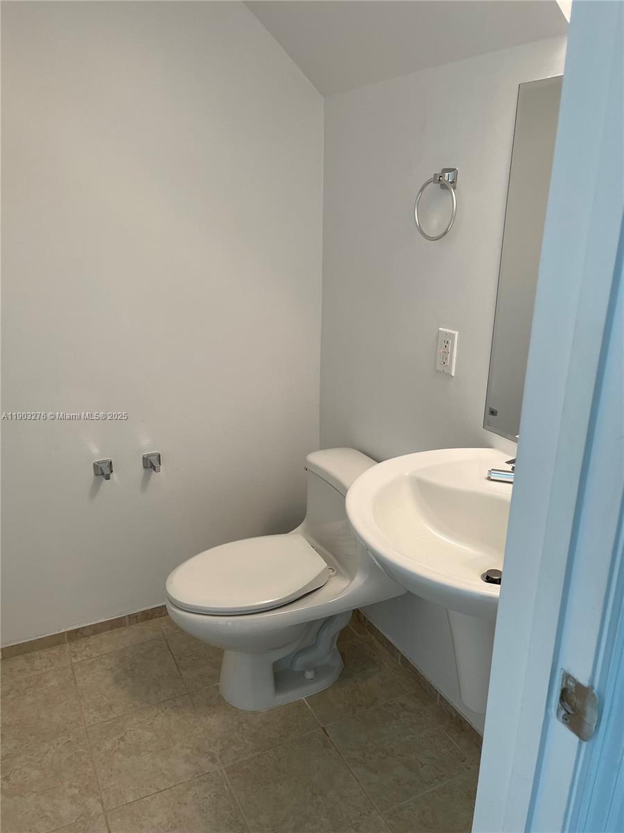60 Southwest 13th Street, Unit 2213 Miami, FL 33130 - Photo 6 of 19 a white toilet sitting next to a white sink