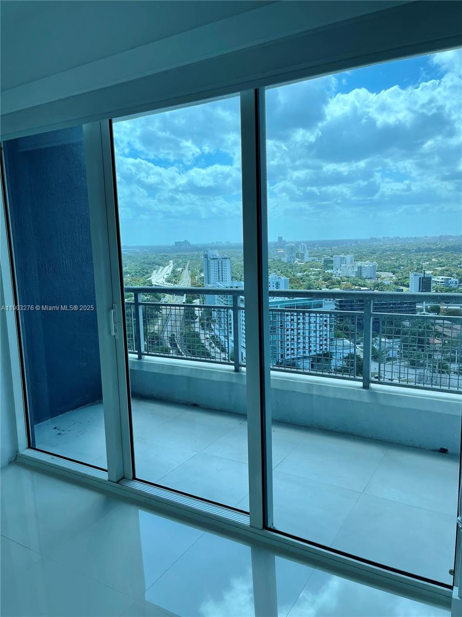 60 Southwest 13th Street, Unit 2213 Miami, FL 33130 - Photo 10 of 19 a view of a glass door and a balcony