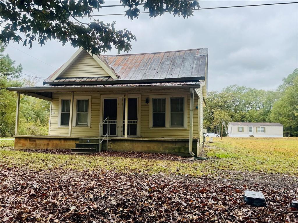 112 Cemetery Street Kingston, GA 30145 - Photo 2 of 28 a front view of a house with a garden