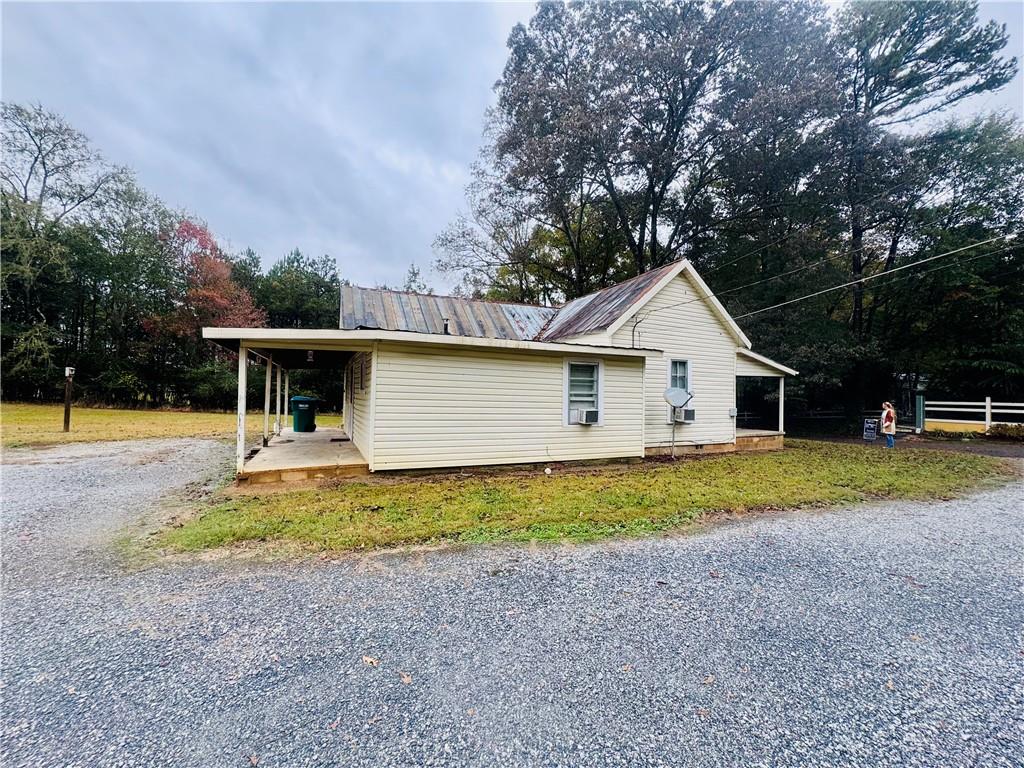 112 Cemetery Street Kingston, GA 30145 - Photo 4 of 28 a view of a house with backyard and trees