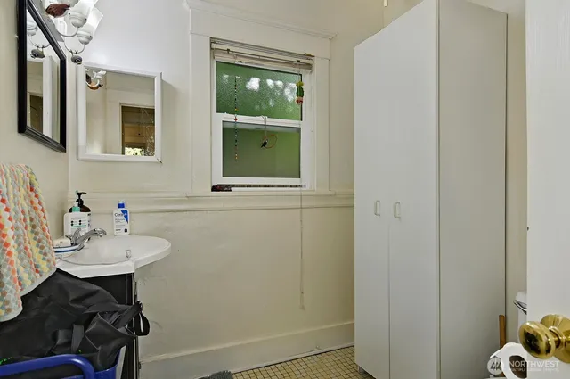 a bathroom with a sink a toilet and mirror