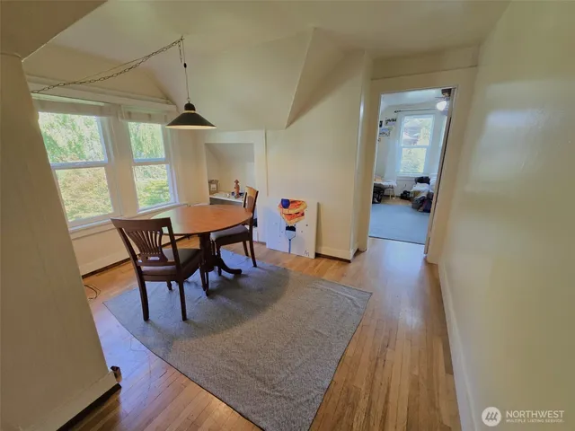 a bedroom with a bed and large windows