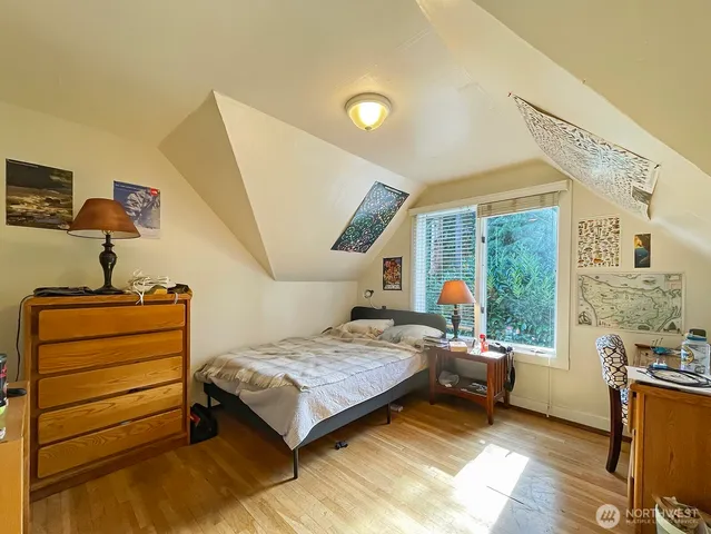 a front view of house with yard and trees in the background