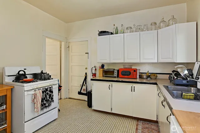 a kitchen with stainless steel appliances granite countertop a stove and a sink