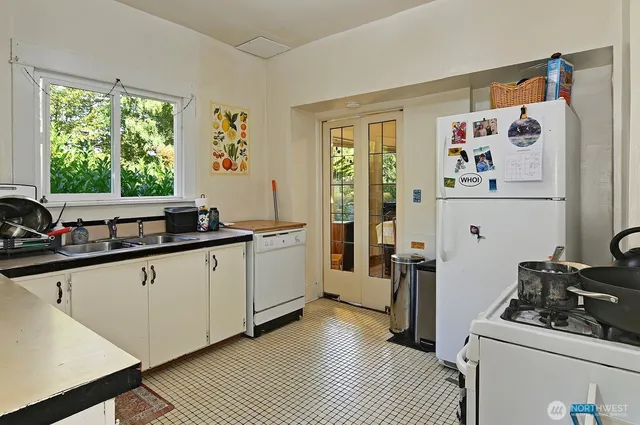 a kitchen with a refrigerator and a sink