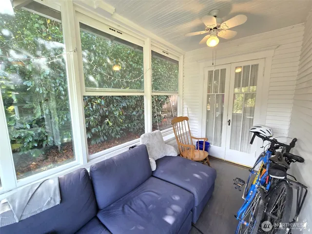 a living room with furniture and a floor to ceiling window