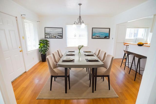 a view of a dining room with furniture window and wooden floor