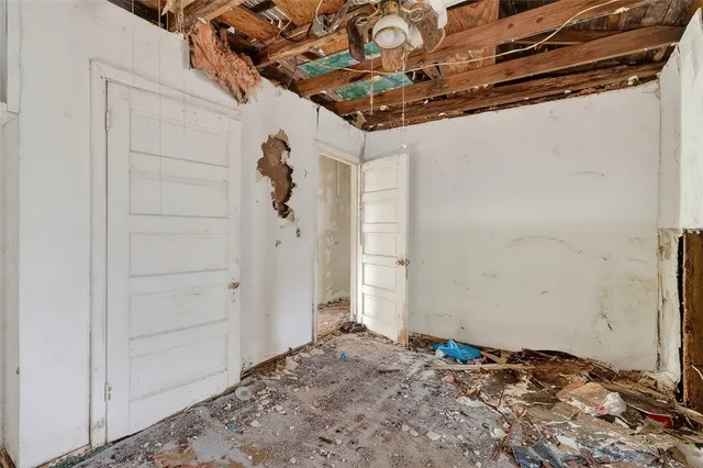 a view of a bedroom with a bed and a window