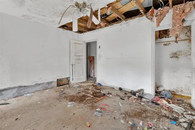 a view of a bedroom with a bed and a window