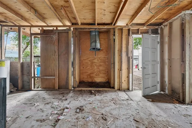 a view of a hallway with wooden walls