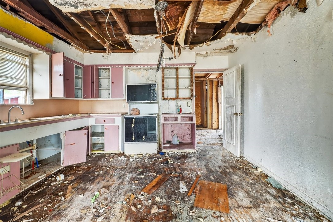 1930 Sandy Way Corpus Christi, TX 78418 - Photo 5 of 35 a room with stainless steel appliances kitchen island granite countertop a stove and a sink