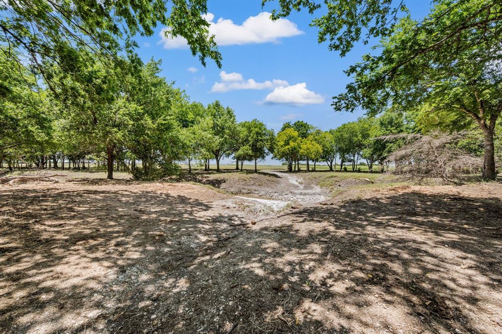 1216 W Road Waxahachie, TX 75165 - Photo 30 of 40 a view of dirt field with trees