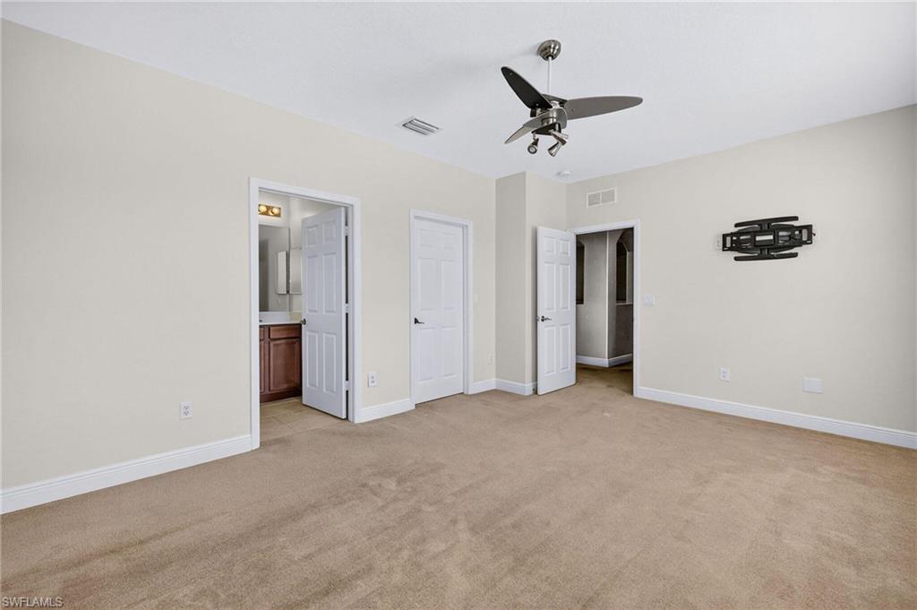 2212 Vardin Place Naples, FL 34120 - Photo 23 of 50 a view of an empty room with a ceiling fan