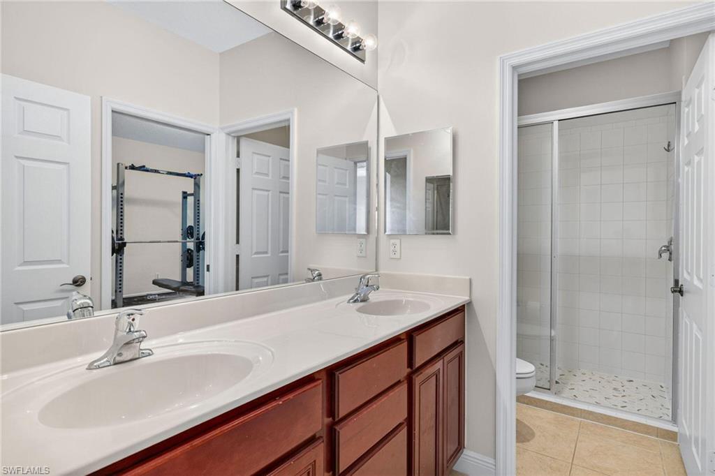 2212 Vardin Place Naples, FL 34120 - Photo 26 of 50 a bathroom with a sink double vanity and a mirror