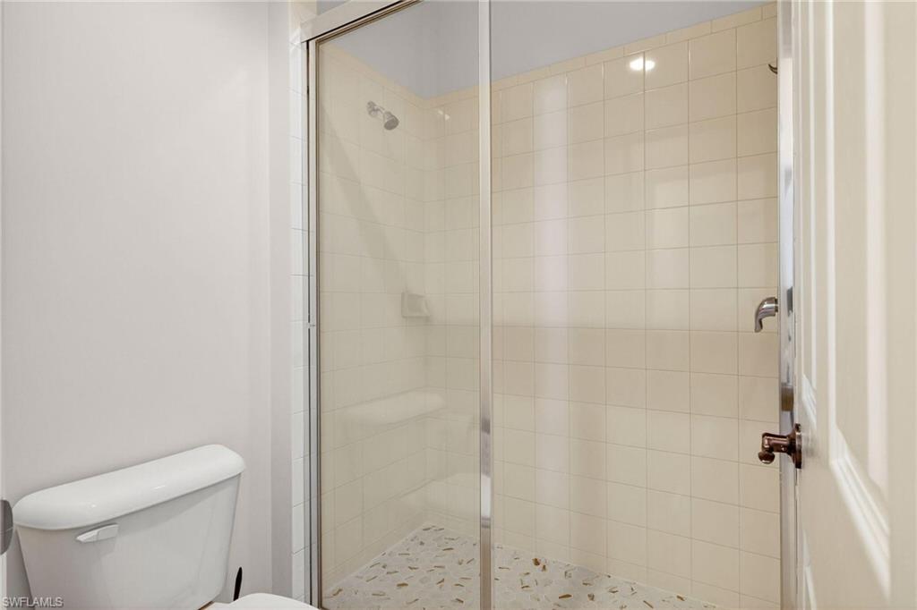 2212 Vardin Place Naples, FL 34120 - Photo 27 of 50 a bathroom with a shower and a toilet