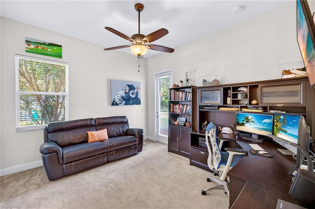 2212 Vardin Place Naples, FL 34120 - Photo 32 of 50 a living room with furniture a flat screen tv and a window