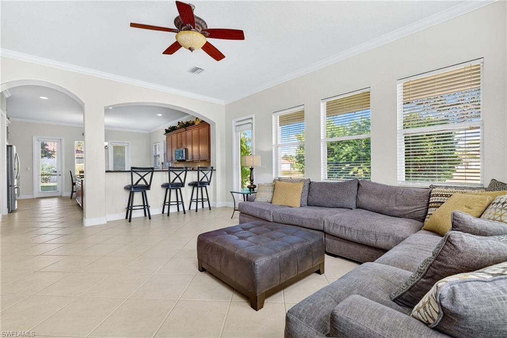 2212 Vardin Place Naples, FL 34120 - Photo 4 of 50 a living room with furniture and a large window