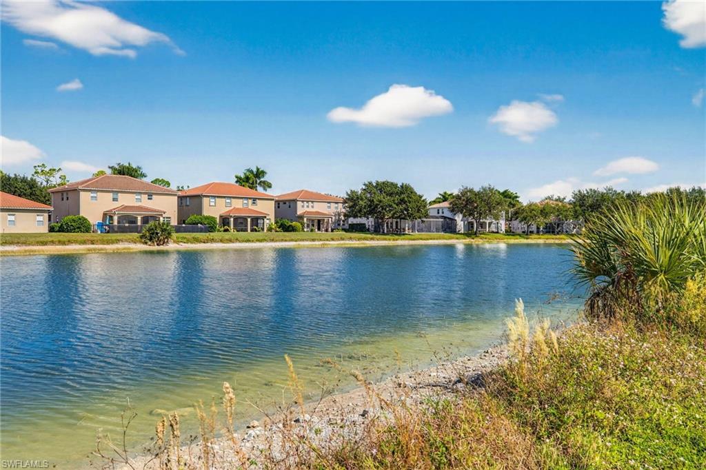 2212 Vardin Place Naples, FL 34120 - Photo 41 of 50 a view of a lake with houses