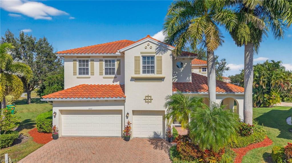 2212 Vardin Place Naples, FL 34120 - Photo 42 of 50 a front view of a house with a yard and garage
