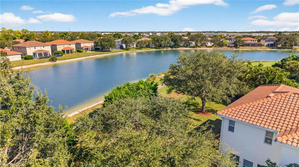2212 Vardin Place Naples, FL 34120 - Photo 44 of 50 a view of a lake with a city