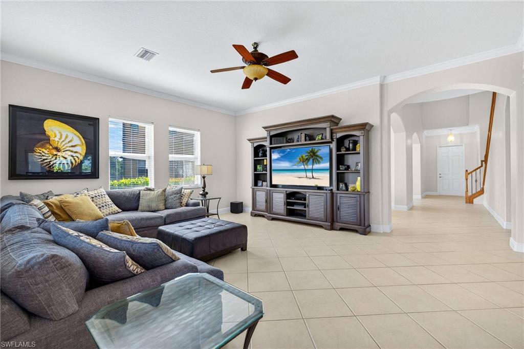 2212 Vardin Place Naples, FL 34120 - Photo 5 of 50 a living room with furniture and a flat screen tv