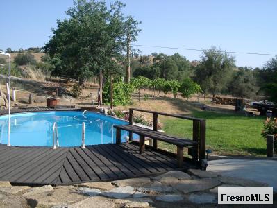 16035 Morgan Canyon Road Prather, CA 93651 - Photo 4 of 6 POOL AND GRASSY PLAY AREA