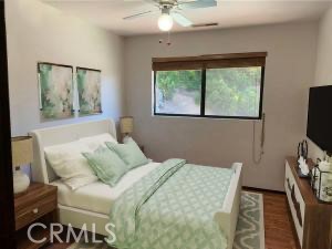 18683 Morgan Valley Road Lower Lake, CA 95457 - Photo 13 of 16 a bedroom with a bed and a flat tv screen on a dresser