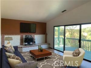 18683 Morgan Valley Road Lower Lake, CA 95457 - Photo 8 of 16 a living room with fireplace furniture and a flat screen tv