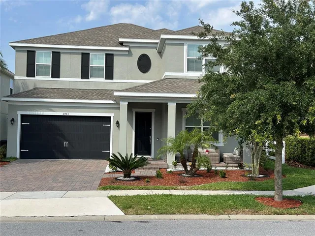 a front view of a house with a yard garage and outdoor seating