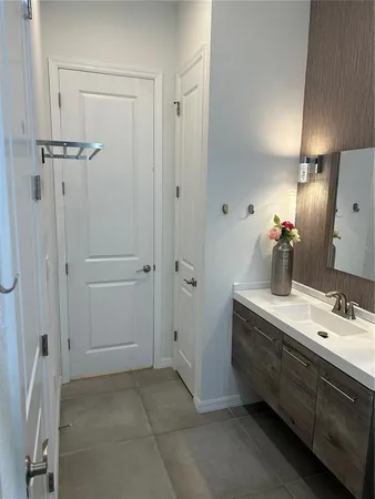 a bathroom with a double vanity sink a mirror and shower