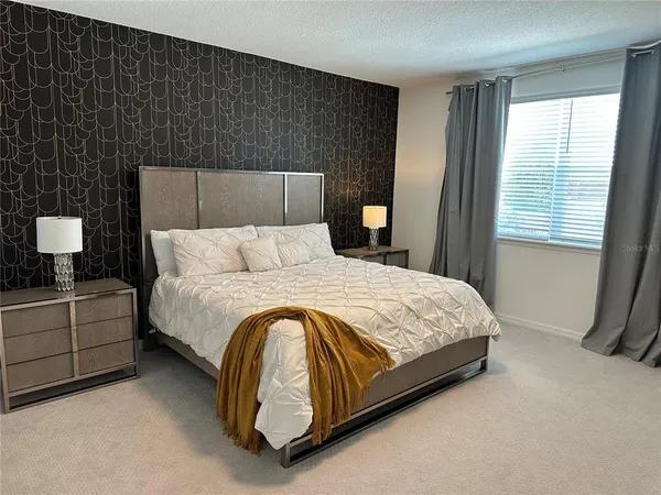 a bedroom with a bed and window