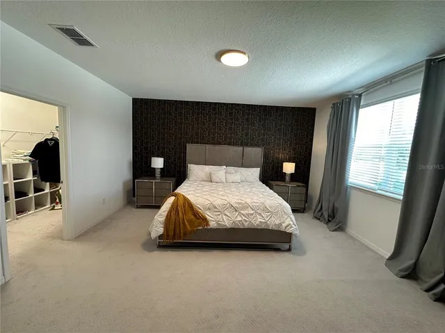 a bedroom with a bed and chair