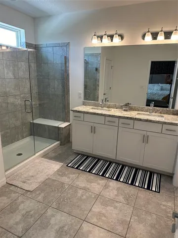 a bathroom with a tub sink and mirror